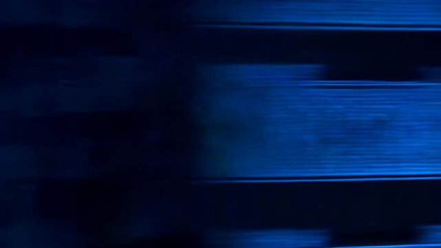 Low viewpoint server aisle with glossy cables and glowing LED racks under cool blue lighting