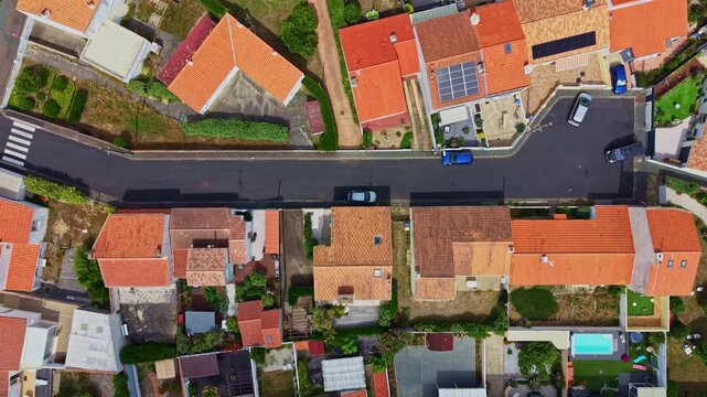 Drone flies above residential rooftops and streets in Sables d'Olonne.