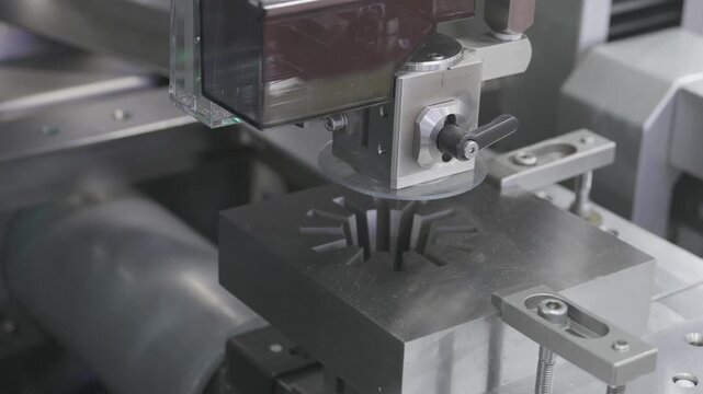 EDM Wire cutting machine working, Closeup Wire Electrical Discharge Machining high precision cut.
