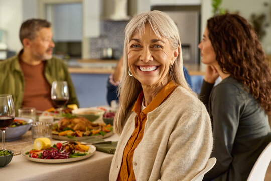 Portrait of mature woman enjoying lunch with family