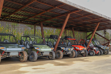 Row Of Off Road Buggies Parked Neatly Under A Wooden Shelter © Queenmoonlite Studio