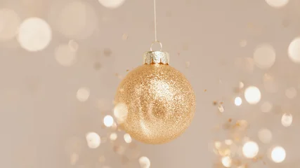Gold glittering Christmas bauble hangs amid luminous soft bokeh. Luxury corporate New Year celebration background template. 3d rendering © vpanteon