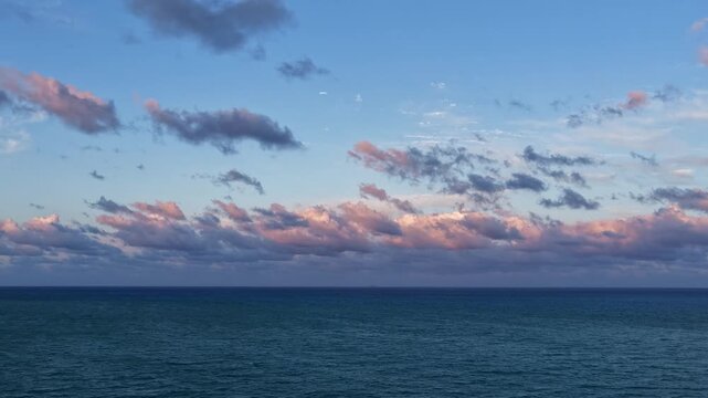 Skyscape with sea sunset. Horizon sunrise sky hyperlapse. Sunrise seascape. Hyperlapse summer seascape. Sea cloudscape horizon hyperlapse. Sunset cloudy dramatic sky. Skyscape at summer vacation