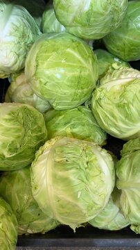 Fresh green cabbages stacked closely together, showcasing texture and natural color
