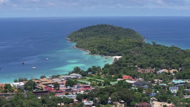 Aerial drone view of Koh Lipe island, Satun, Thailand. Turquoise sea, coral reefs, white sand beaches and traditional long-tail boats in the Andaman Sea.
