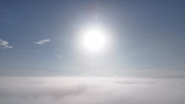 Sun Shining Above Cloud Layer and Blue Sky in 4K