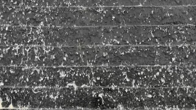 The Monolithic Descent of Monochromatic Torrent Cascading Over Sculpted Dark Stone Wall