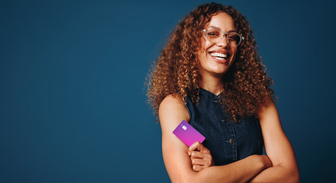 Money and credit themes surround the woman in a blue studio card portrait