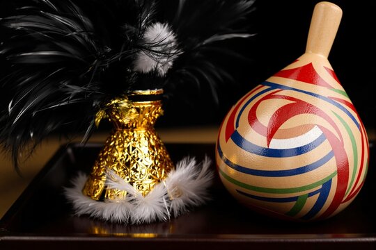 Close-up still life of traditional Japanese New Year game objects with hanetsuki shuttlecock and wooden spinning top koma