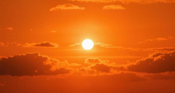 Concept or background for climate change, heat wave or global warming, orange sky with clouds and bright sun
