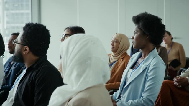 A diverse audience of professionals attends a modern business conference, engaged and focused. This event showcases learning, networking, and collaboration in a global corporate environment.