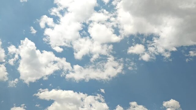 Brilliant whitish cumulus clouds in the sky in afternoon