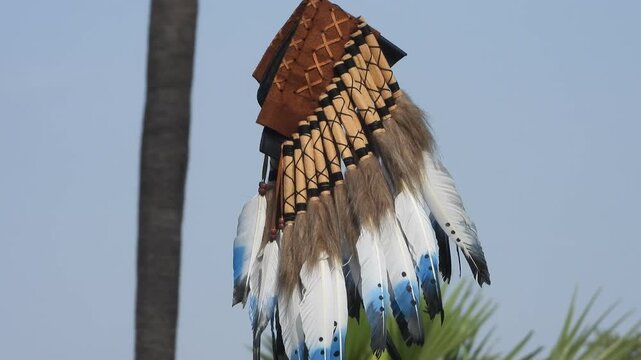 A Native American headdress in wind .