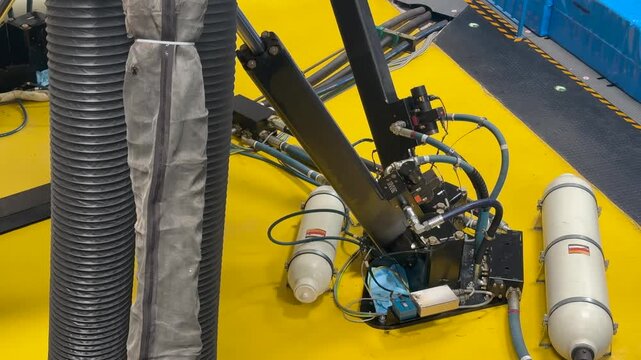 closeup view of the leg and hydraulic system of a full motion flight simulator in operation in a training session.