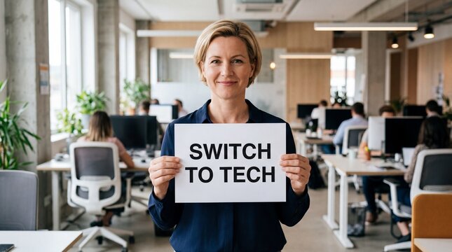 Middle-aged caucasian businesswoman holds a switch to tech sign in a modern open office