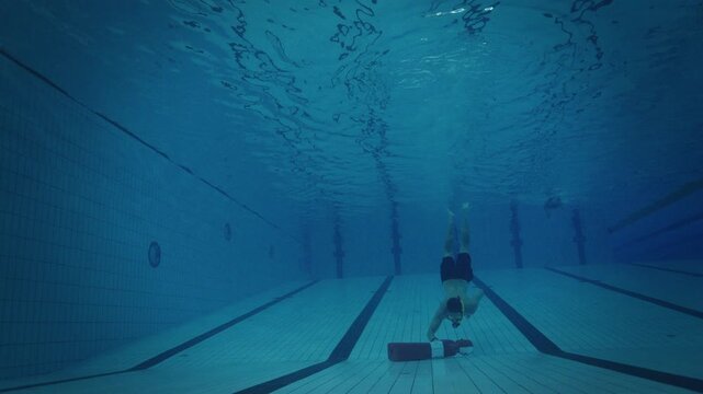 Freediver Descending to Rescue Manikin