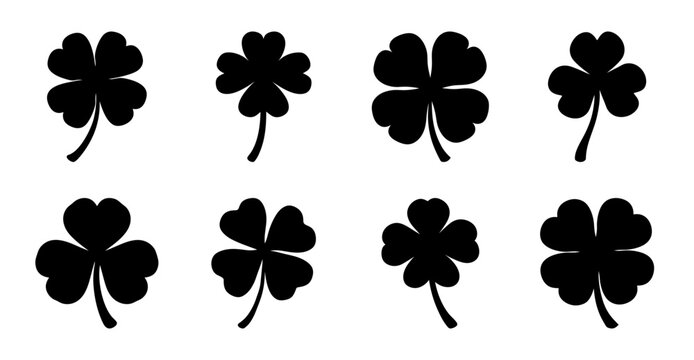 Four leaf clover icons in black and white - Simple set of four leaf clover icons arranged neatly, perfect for luck-themed designs or illustrations.