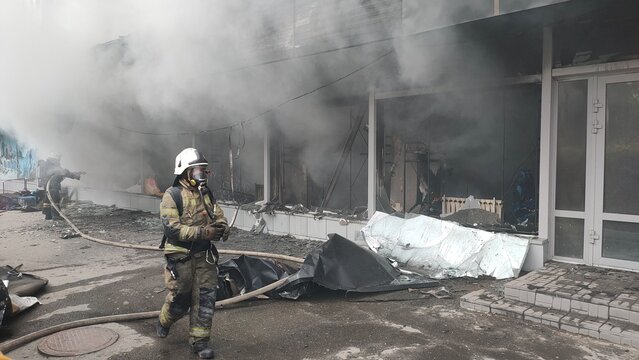 Firefighters extinguish a burning store. Fire in a house and insurance.