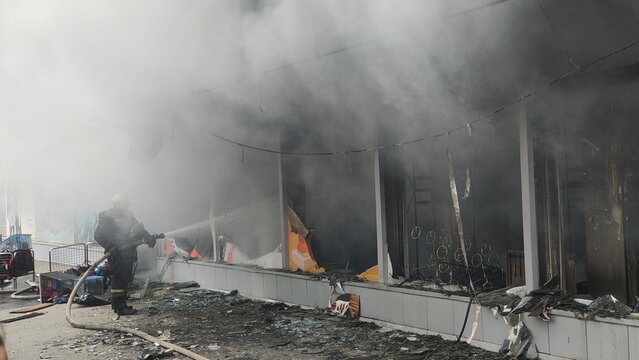 Firefighters extinguish a burning store. Fire in a house and insurance.