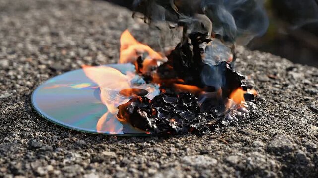Toxic Smoke Billowing from a Melting CD Catching Fire on Dark Background