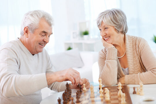 Senior couple playing chess together