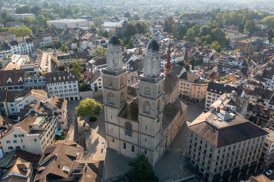 Aerial view of Grossmunster church with its iconic twin towers, surrounded by historic old town buildings and urban architecture in the city center, Zurich, Zurich, Switzerland.