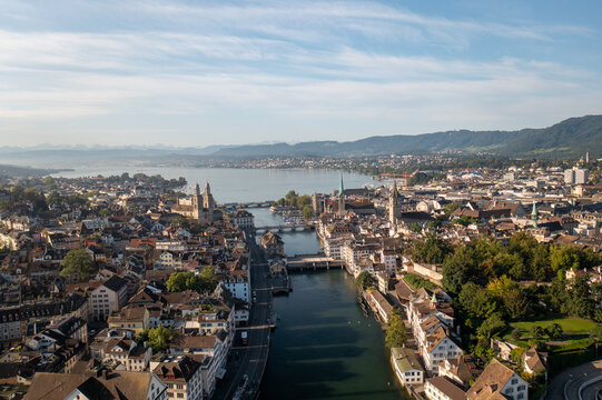 Aerial view of the historic city of Zurich with the Limmat River, traditional rooftops, church spires, and Lake Zurich in the background, Zurich, Zurich, Switzerland.