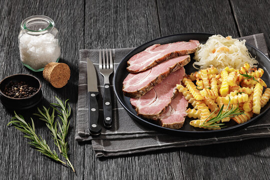 pork neck slices with sour cabbage, french fries