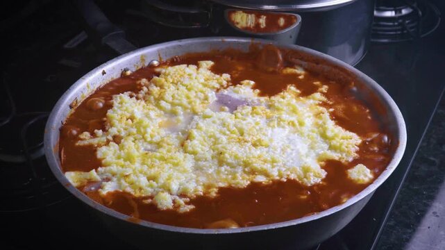 Removing lid from boiling skillet lasagna with cheese