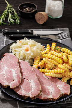 pork neck slices with sour cabbage, french fries
