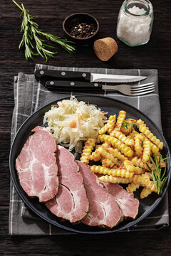 pork neck slices with sour cabbage, french fries