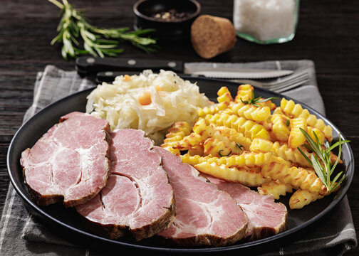 pork neck slices with sour cabbage, french fries