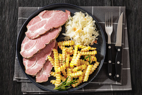 pork neck slices with sour cabbage, french fries