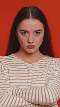 Angry aggressive pretty woman showing fig negative gesture, you dont get it anyway. Rapacious, avaricious, acquisitive. Body language. Refusal fig sign. Greedy avaricious girl on red background