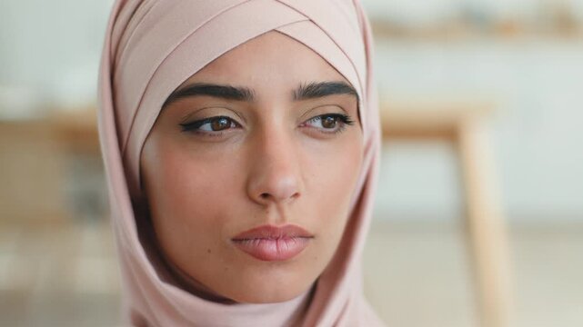 Muslim Arabian woman in hijab thinking serious looking at camera indoors female Islamic girl portrait headshot natural make up skin care anti acne remedy thoughtful young lady beauty health treatment