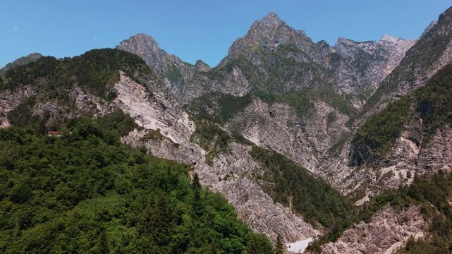 Deep mountain valley facing the majestic Friulian Dolomites. Nature panorama drone flight, Italy.