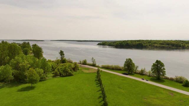 Aerial view of the tree-lined 45th Parallel corridor on Macdonell Island in Ontario, Canada, highlighting this geographic landmark within the scenic St. Lawrence River region.
