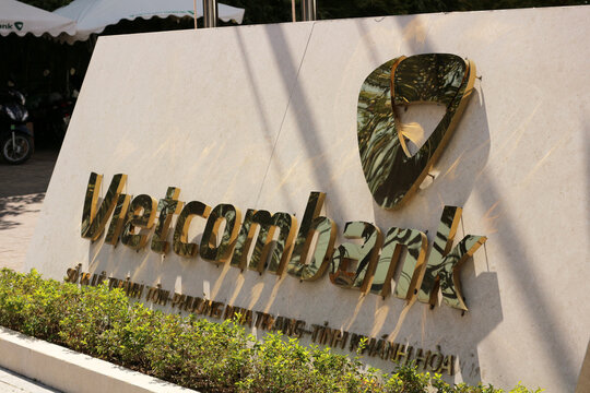 NHA TRANG, VIETNAM - JANUARY 26, 2026: Сlose-up diagonal view of the shiny golden Vietcombank corporate sign letters and 3D logo.