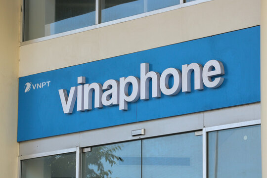 NHA TRANG, VIETNAM - JANUARY 26, 2026: A blue corporate sign board with Vinaphone mobile network operator logo and lettering displayed on a building.