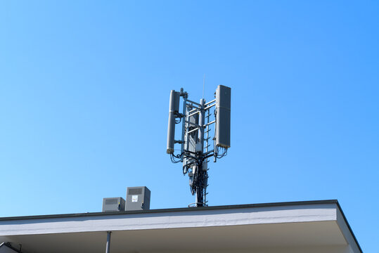 Mobile phone antenna on rooftop of apartment building at Swiss city of Z&uuml;rich on a sunny hot summer day. Photo taken June 24th, 2026, Zurich Seebach, Switzerland.