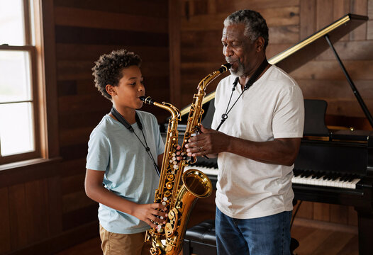 African American Grandfather Teaching Grandson Saxophone