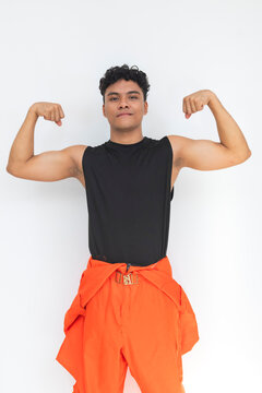 Young Filipino seafarer confidently flexing his arm muscles, showcasing physical strength, fitness, endurance, and readiness for demanding maritime work.