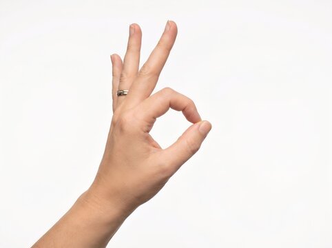 Human hand showing okay gesture sign isolated on white background for success symbol