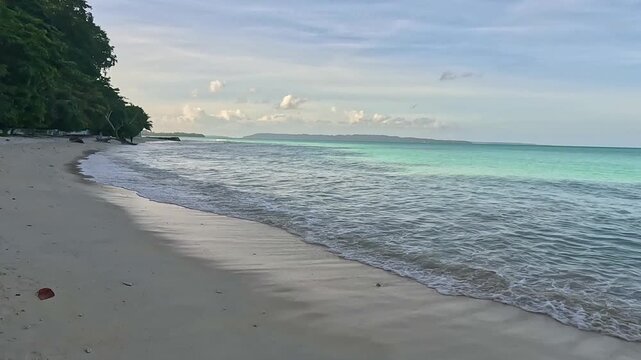 Serene Tropical Beach with Turquoise Water and White Sand at Sunset