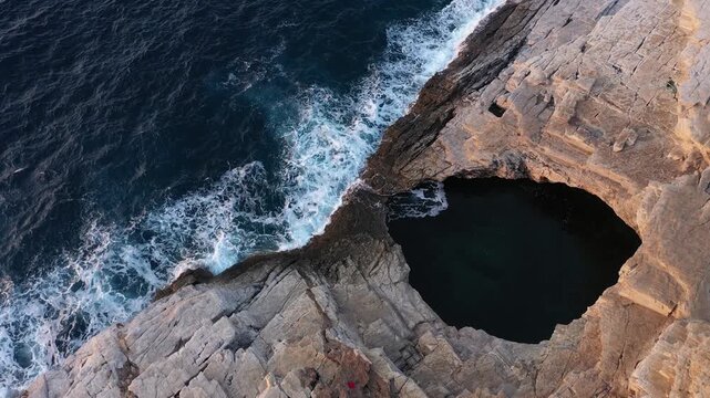  Flying above epic seaside natural rocky pool. Giola lagoon, Thassos island, Greece, aerial slow motion view