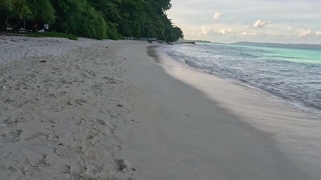 Serene Tropical Beach Landscape with Turquoise Ocean Waves Crashing on Rock Formation