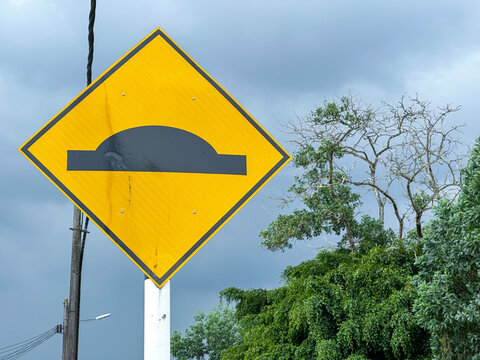 Malaysian Road Signs in Residential Area Under Cloudy Sky