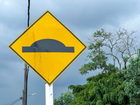 Malaysian Road Signs in Residential Area Under Cloudy Sky