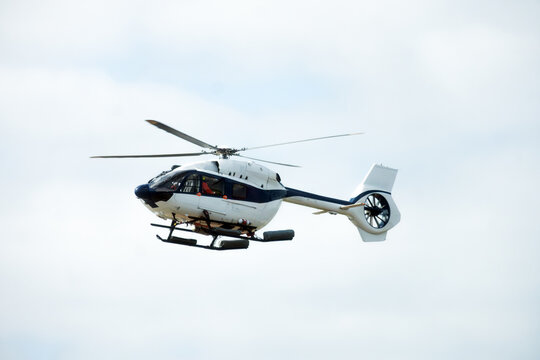 Civil Protection Search and Rescue Helicopter Flying Against Bright Sky, Concept of Air Transportation