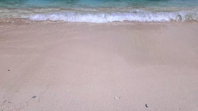 static shot of ocean with calm waves reaching shore of white sand beach on tropical during sunny day, holidays, vacations, relax, paradise and tourism concept, copy space